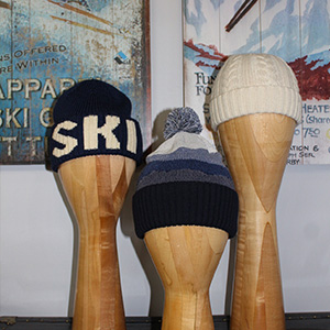 Photo of three dummy heads displaying knit caps